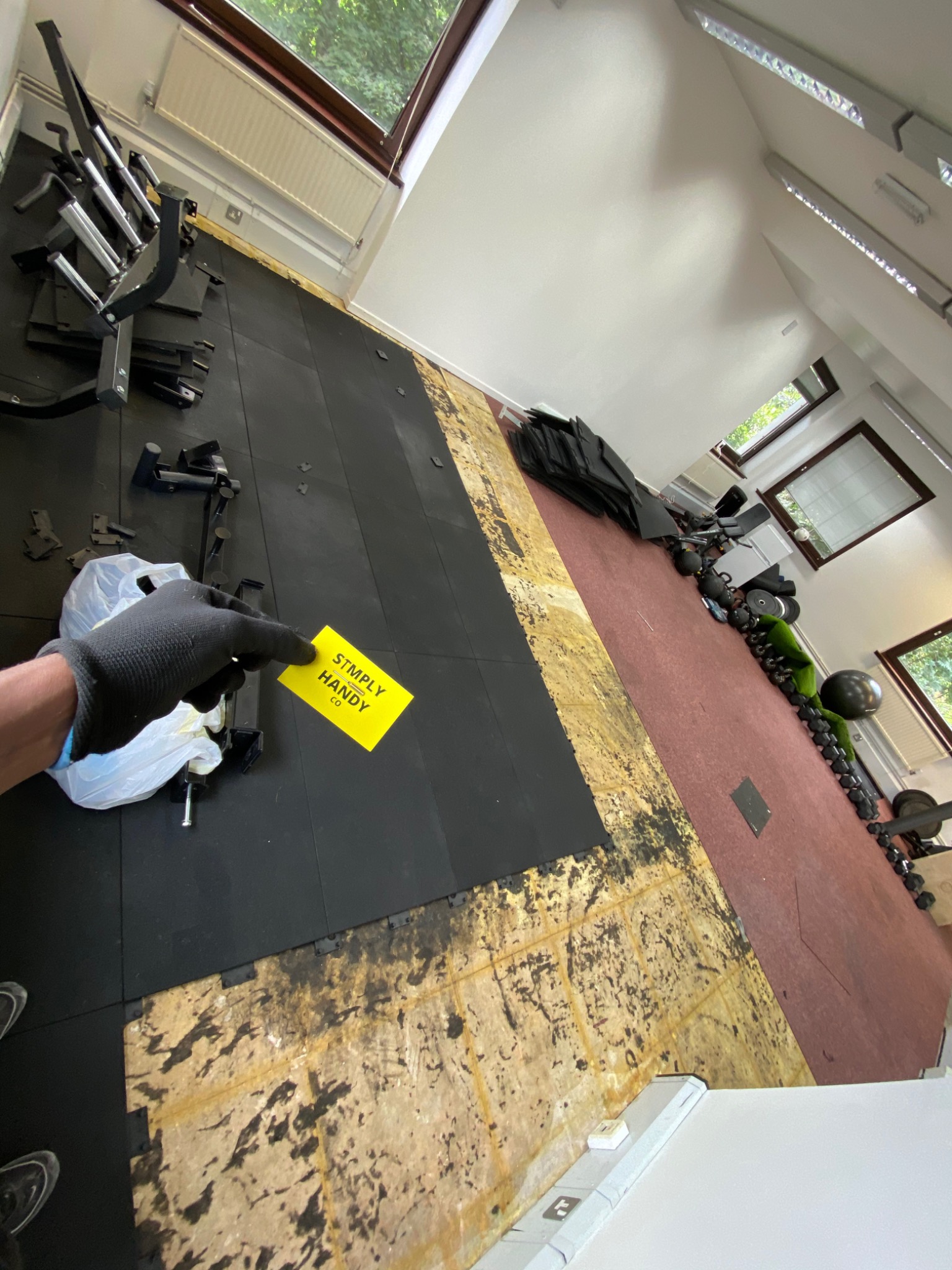 Before: the gym during its refit, with sections of flooring exposed and equipment awaiting setup.