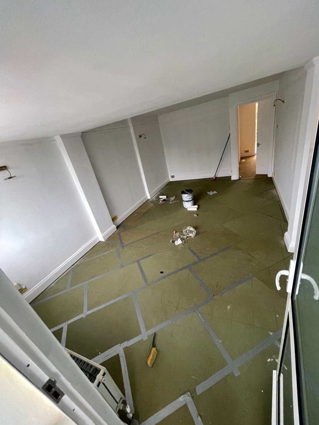 Before: Living and dining area with the floor protected during renovation.